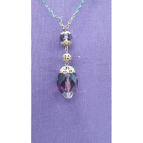 197 - AN AMETHST AND CRYSTAL SET PENDANT ON GILT CHAIN