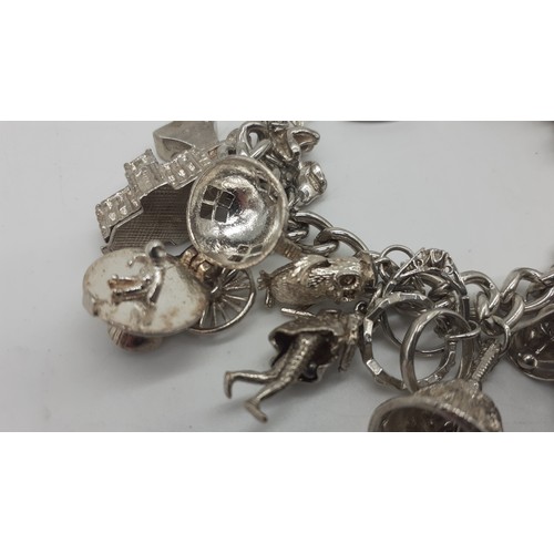 256 - A BEAUTIFUL HEAVY SILVER CHARM BRACELET WITH 20 CHARMS 105.4 grms