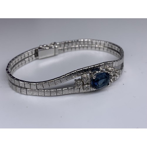 339 - A SAPPHIRE AND CRYSTAL WHITE METAL BRACELET