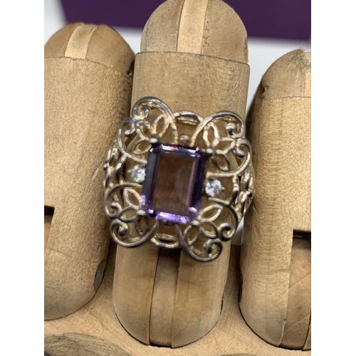 341 - A SILVER OPENWORK & PURPLE STONE RING