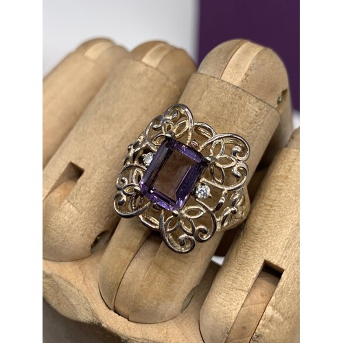 341 - A SILVER OPENWORK & PURPLE STONE RING