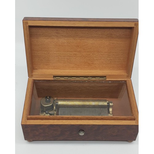 630 - AN AMBOYNA CASED MUSICAL BOX (PWO) 7 X 4 X 3IN