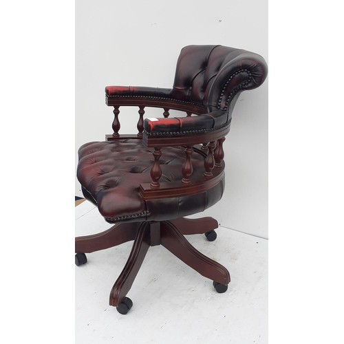 569 - AN OXBLOOD  DEEP BUTTONED CAPTAINS/DESK SWIVEL CHAIR