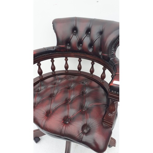 569 - AN OXBLOOD  DEEP BUTTONED CAPTAINS/DESK SWIVEL CHAIR