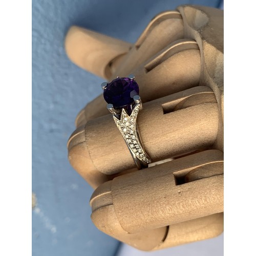 681 - AN AMETHYST AND DIAMOND RING OVAL AMETHYST 3CTS WEIGHT SET WITH FANCY DESIGN SHOULDERS WITH 25 BRILL... 