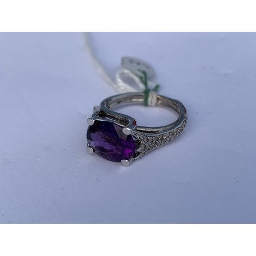 681 - AN AMETHYST AND DIAMOND RING OVAL AMETHYST 3CTS WEIGHT SET WITH FANCY DESIGN SHOULDERS WITH 25 BRILL... 