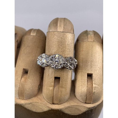 684 - STUNNING MULTI DIAMOND RING IN 18CT WHITE GOLD MAKES UP 3 DIASY STYLE PATTERNS