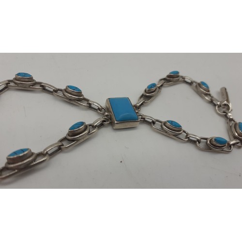 643 - A SILVER AND TURQUOISE BRACELET