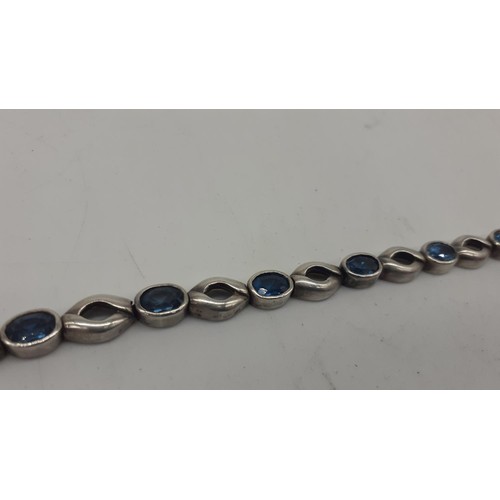 258 - A SILVER AND BLUE TOPAZ BRACELET