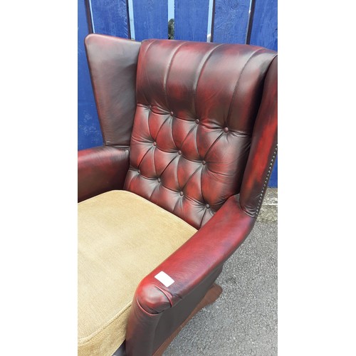 587 - A DEEP BUTTONED OXBLOOD ROCKING CHAIR