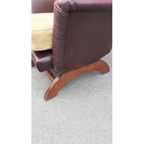 587 - A DEEP BUTTONED OXBLOOD ROCKING CHAIR