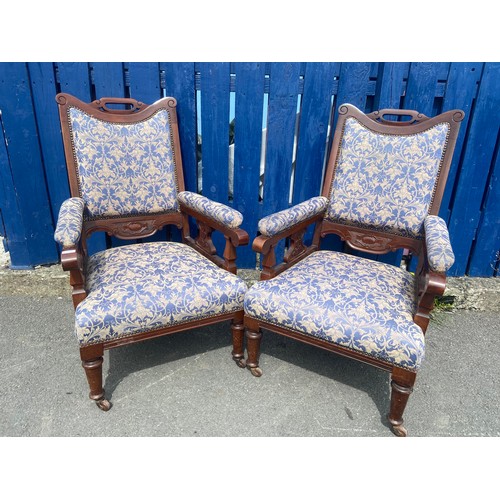 750 - A PAIR OF VICTORIAN WALNUT FRAMED ARMCHAIRS IN A BLUE AND GILT MATERIAL