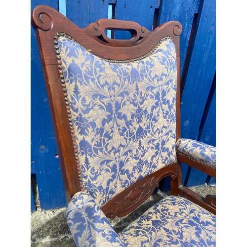 750 - A PAIR OF VICTORIAN WALNUT FRAMED ARMCHAIRS IN A BLUE AND GILT MATERIAL