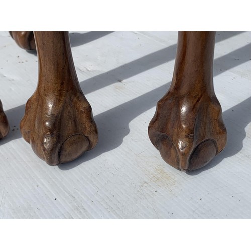 711 - ANTIQUE SHAPED WALNUT NEST OF TABLES ON A PAW FOOT