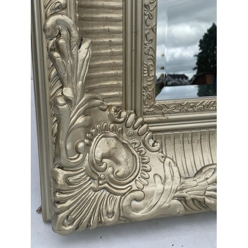 625A - VERY ORNATE SILVER GILT FRAMED MIRROR MEASURES 75 x 31 INCHES