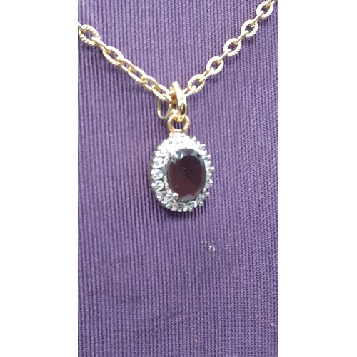 218 - AN AMETHYST AND GEM SET PENDANT ON GILT CHAIN