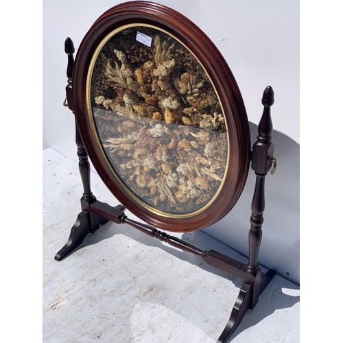 285 - A MAHOGANY FIRESCREEN WITH DRIED FLOWERS