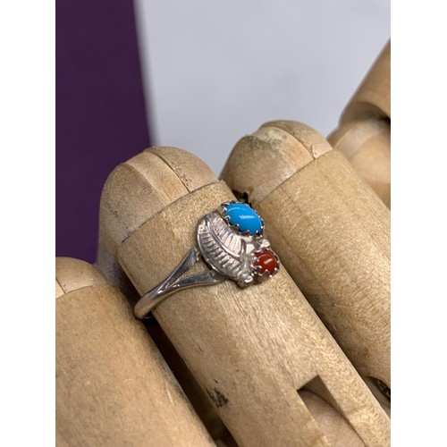 216 - A SILVER TORQUOISE AND RED STONE RING