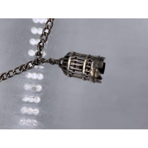 236 - A SILVER CHARM BRACELET WITH FISH,BANJO,OIL CONTAINER AND BIRD CAGE