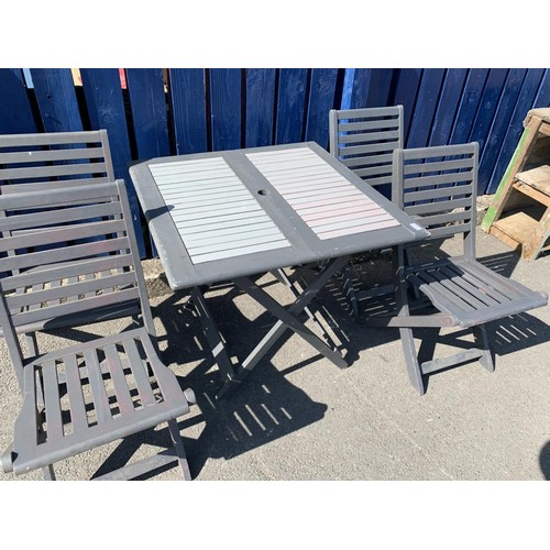 104 - A WOODEN  FOLDING PATIO TABLE AND 4 CHAIRS