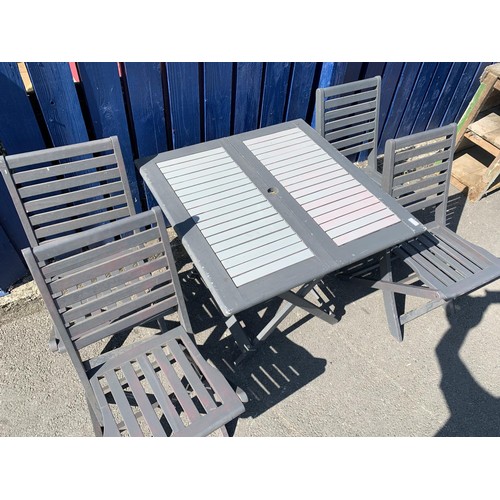 104 - A WOODEN  FOLDING PATIO TABLE AND 4 CHAIRS