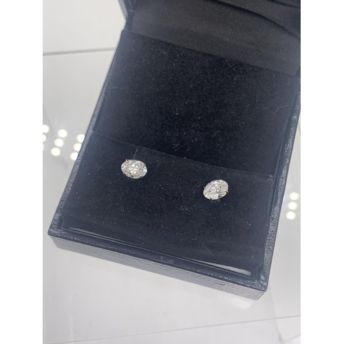 261 - A PAIR OF SILVER SOLITAIRE EARRINGS