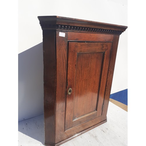 102 - A SMALL ANTIQUE OAK HANGING CORNER CUPBOARD 35x29in