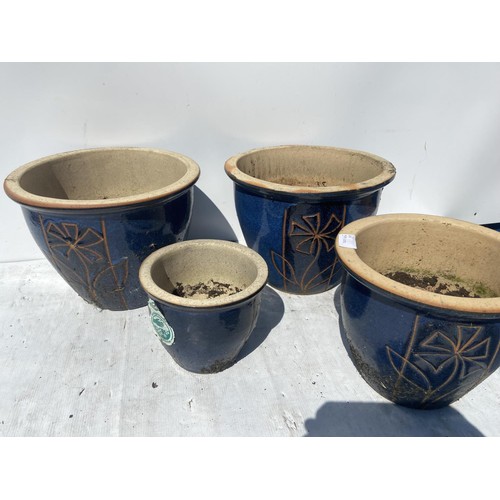 28 - A SET OF 4 MATCHING FLORAL PATTERN PLANTERS