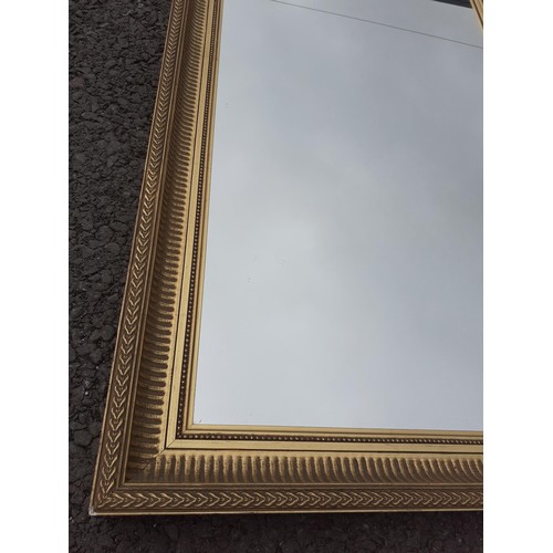 49 - A GILT FRAMED MIRROR 34X18