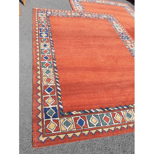 143 - A PAIR OF BURNT ORANGE COLOURED RUGS 54x80in