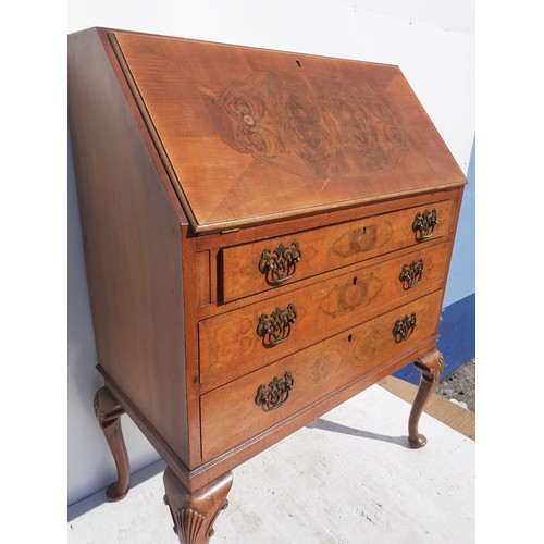 155 - A WALNUT WRITING BUREAU WITH SHELL MOTIF