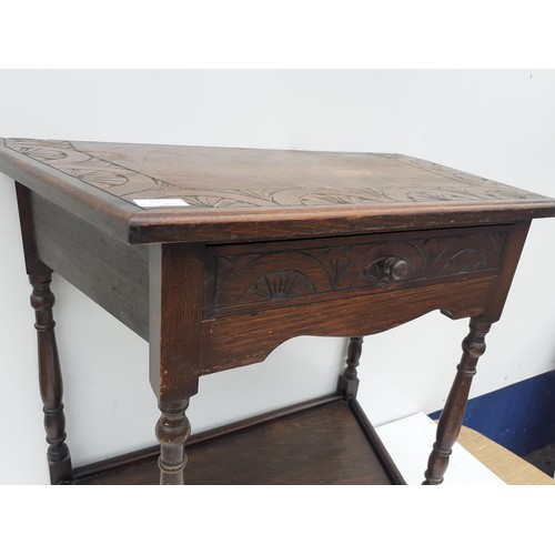 178 - A CARVED OAK CUT CORNER HALL TABLE