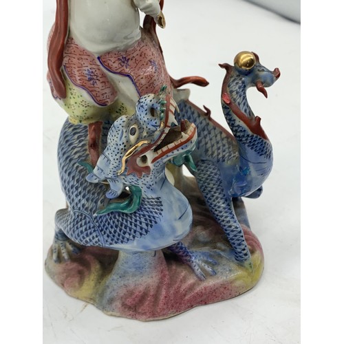 333 - A CHINESE MAN ON DRAGON HOLDING GILT BAND PORCELAIN FIGURE 8