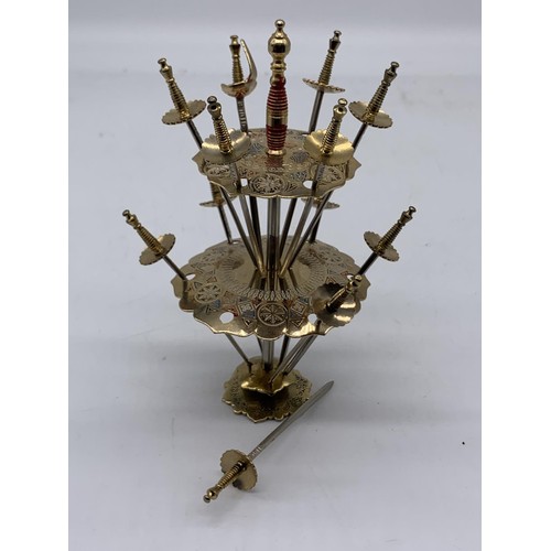 352 - AN INDIAN BRASS SWORD COCKTAIL SET