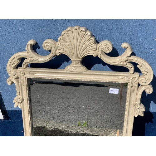 283 - AN ORNATE CREAM FRAMED MIRROR 41 x 24