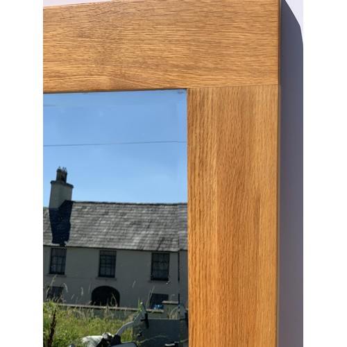 303 - AN OAK BEVELLED FRAMED MIRROR 46 X 24