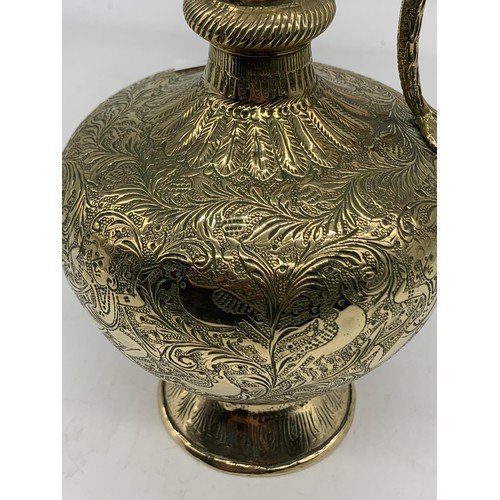 469 - AN INDIAN CHASED BRASS EWER WITH KING COBRA HANDLE 10in