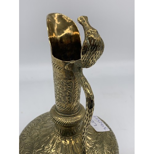 469 - AN INDIAN CHASED BRASS EWER WITH KING COBRA HANDLE 10in