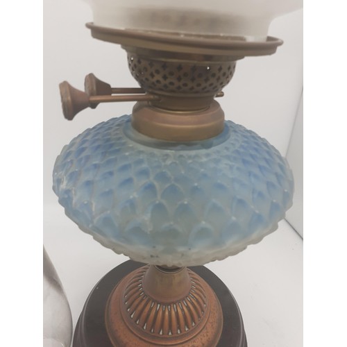 470 - A BLUE GLASS BOWL OIL LAMP WITH FOOTBALL SHADE