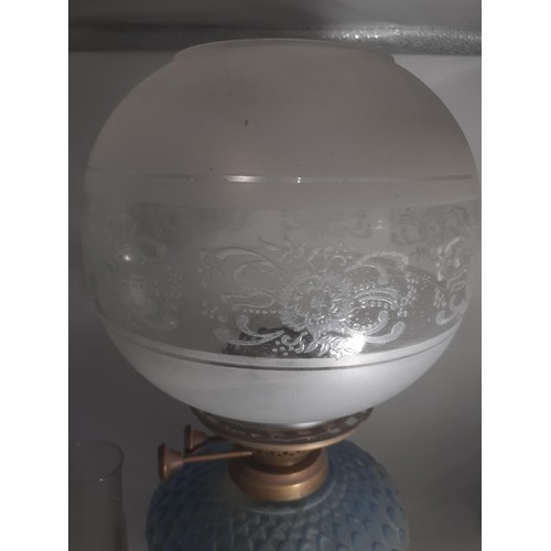 470 - A BLUE GLASS BOWL OIL LAMP WITH FOOTBALL SHADE