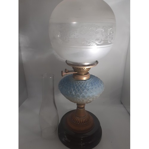 470 - A BLUE GLASS BOWL OIL LAMP WITH FOOTBALL SHADE