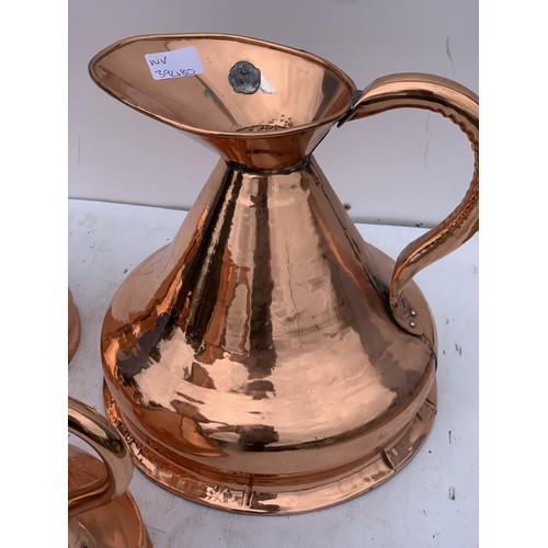 501 - 7 GRADUATED COPPER JUGS