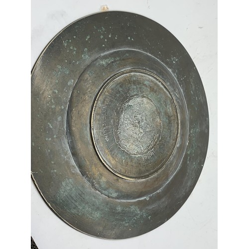 602 - A CHINESE BRASS PLATE DEPICTING  DRAGONS WITH MARKINGS TO BASE 11in Dia