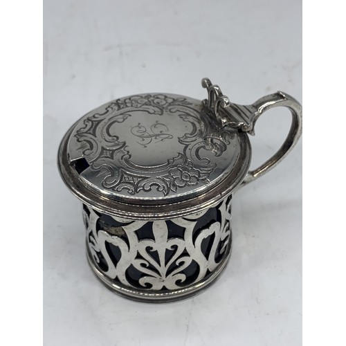 649 - AN ORNATE VICTORIAN LONDON SILVER MUSTARD POT WITH BLUE GLASS LINER silver weight 99.2grms (liner re... 