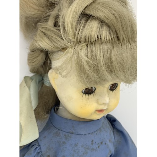 553 - A PORCELAIN HEAD DOLL