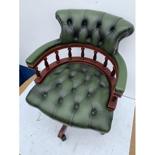 572 - A GREEN LEATHER CAPTAINS CHAIR