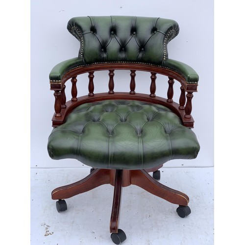 572 - A GREEN LEATHER CAPTAINS CHAIR