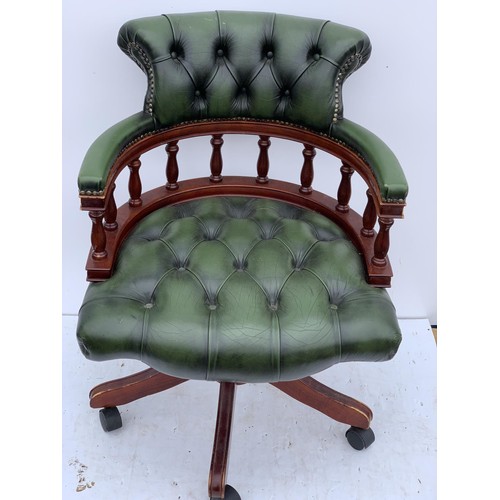 572 - A GREEN LEATHER CAPTAINS CHAIR