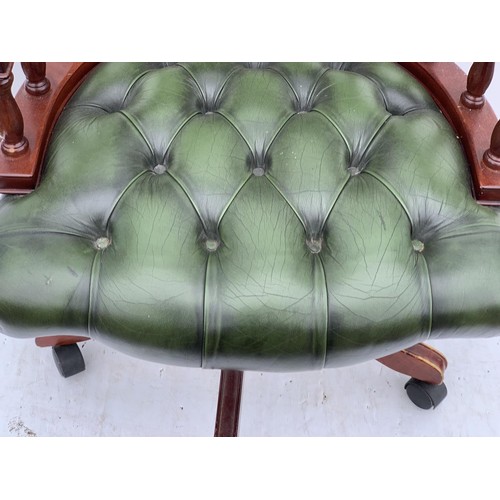 572 - A GREEN LEATHER CAPTAINS CHAIR