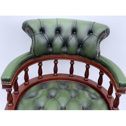 572 - A GREEN LEATHER CAPTAINS CHAIR